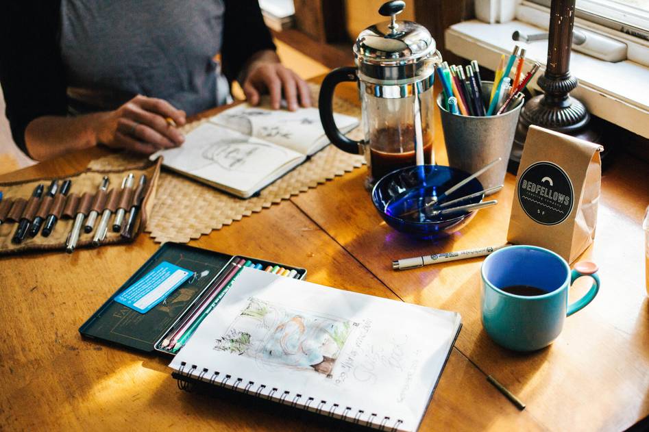 Minimalist desk setup with sketchbook and pencils