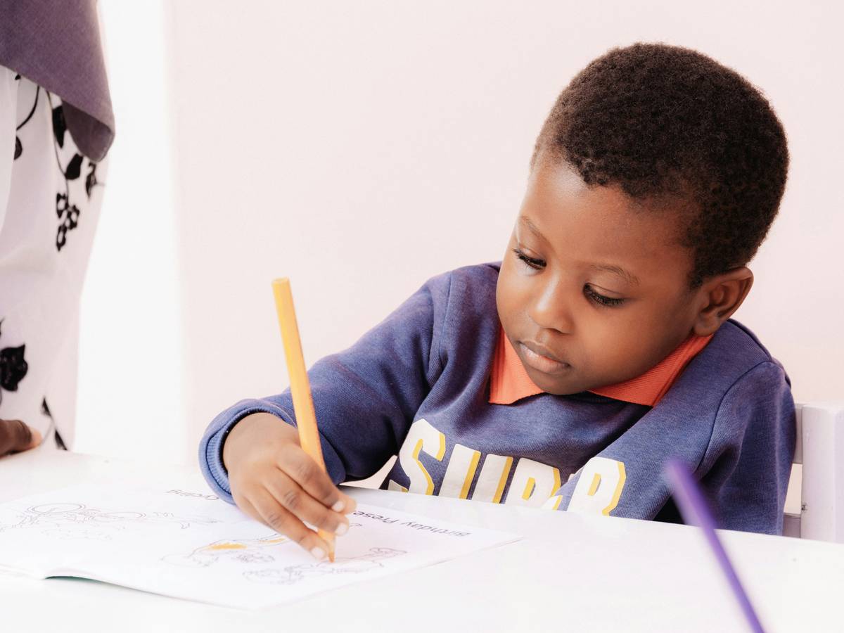 Close-up of child's hands using different pencils demonstrating drawing benefits for children