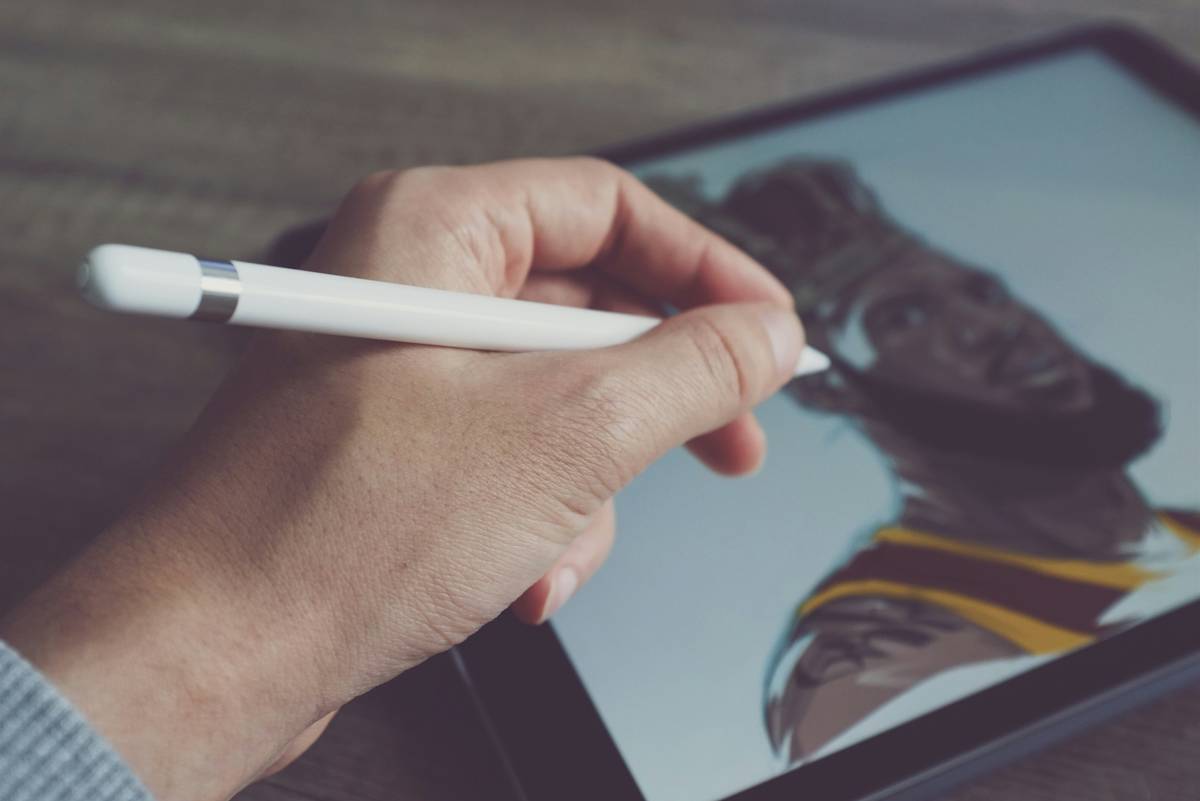 Artist using pencil drawing sketch app on tablet with realistic graphite strokes